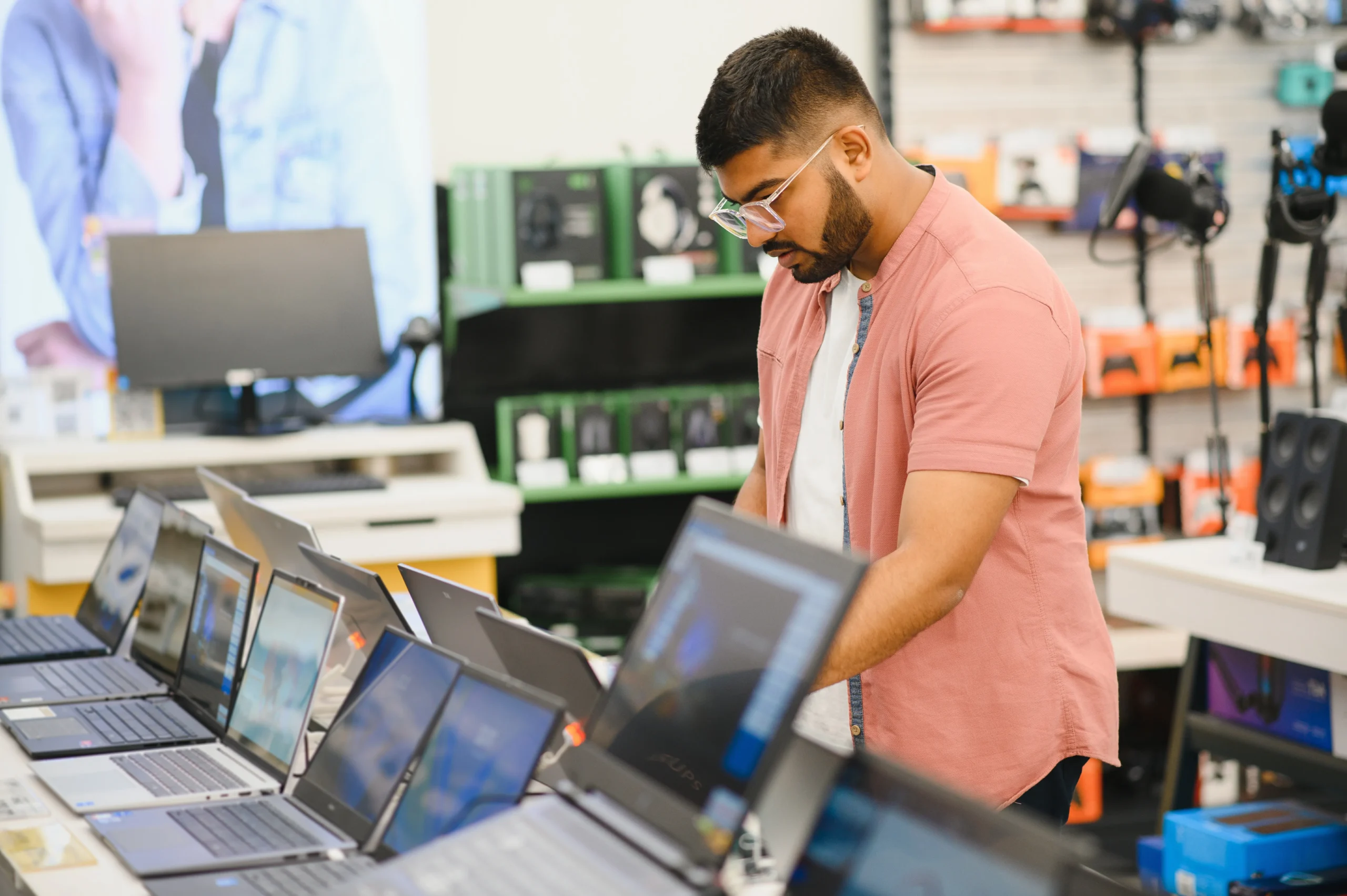 a-young-man-stands-behind-his-laptop-at-the-electr-2025-03-14-22-56-08-utc_11zon
